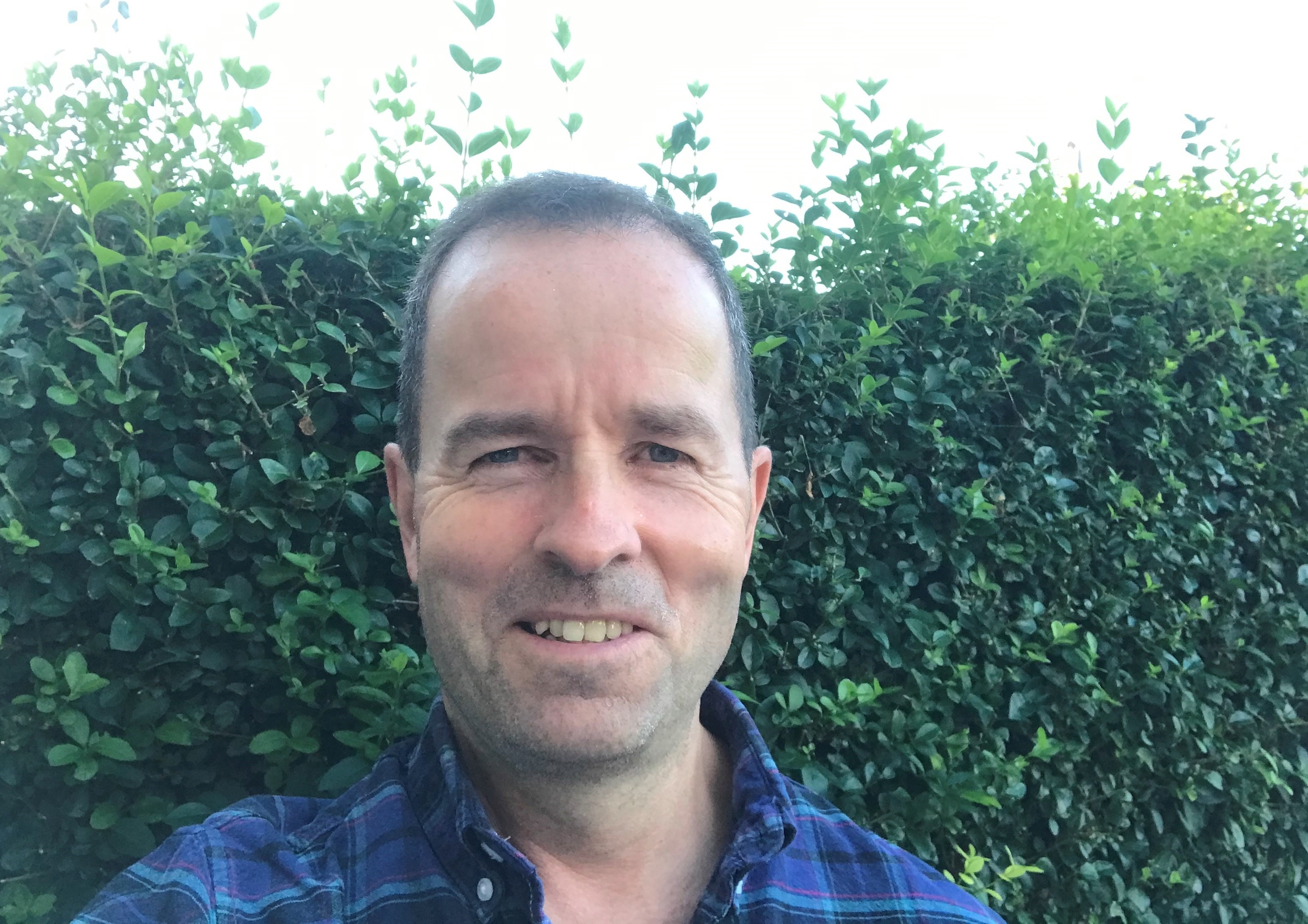 Pat Snowdon in front of bushes