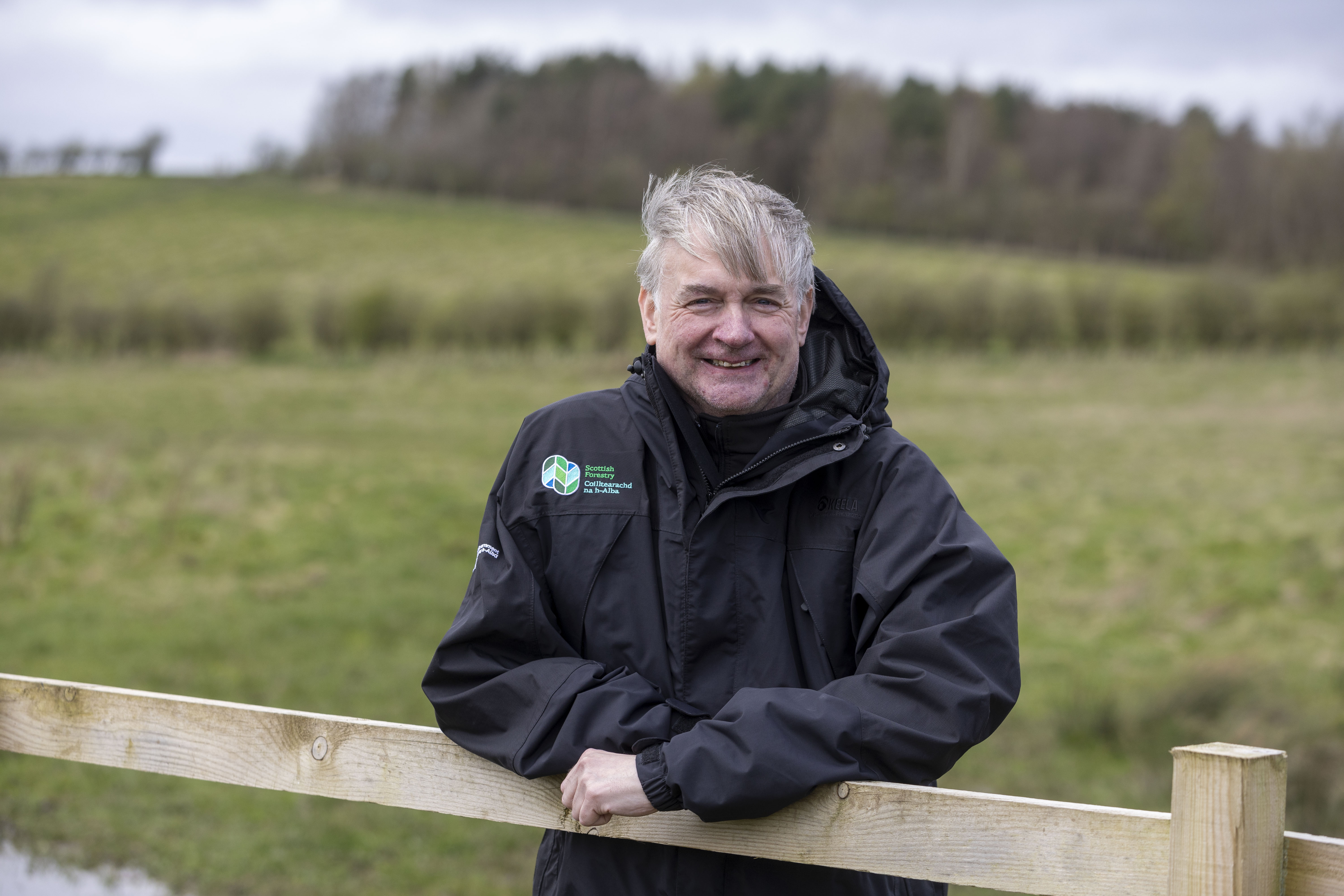 Paul Lowe leaning on a fence